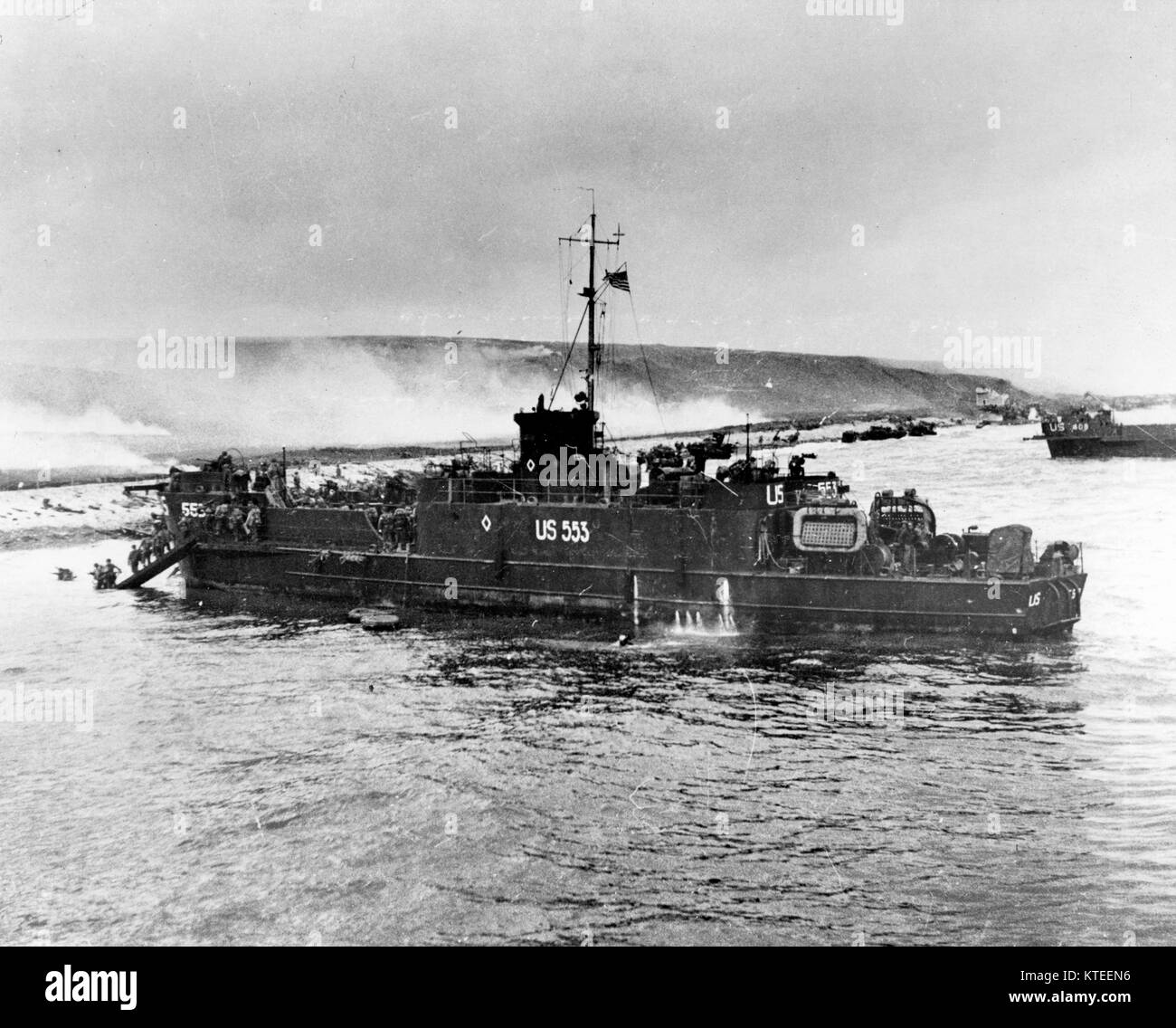 Normandy Invasion, June 1944 - USS LCI(L)-553 lands troops on Omaha Beach, during the initial D-Day assault, 6 June 1944. This LCI(L) was lost during this action. Stock Photo