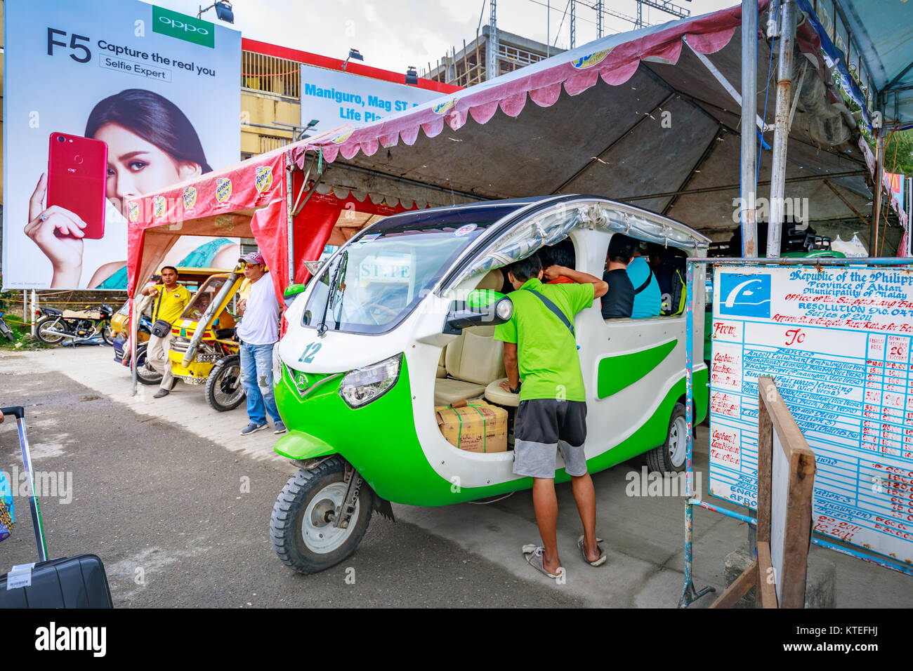 People who ride the green electric car to go to Boracay main