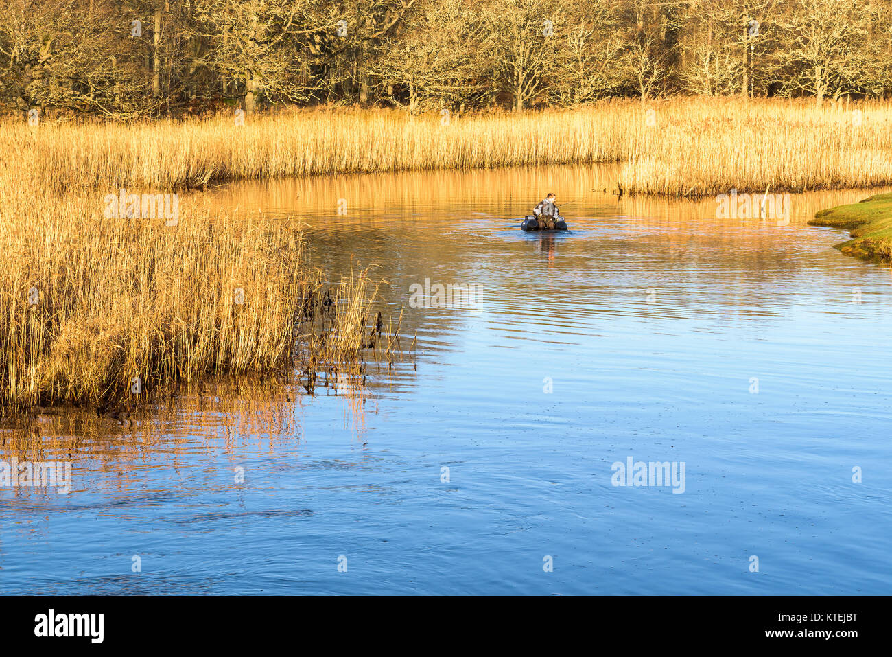 Millegarne, Sweden - December 17, 2017: Documentary of everyday life and environment. Person using an inflatable chair while fly-fishing after pike am Stock Photo
