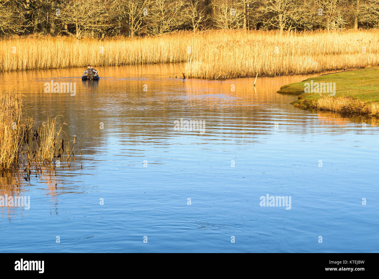 Millegarne, Sweden - December 17, 2017: Documentary of everyday life and environment. Person using an inflatable chair while fly-fishing after pike am Stock Photo