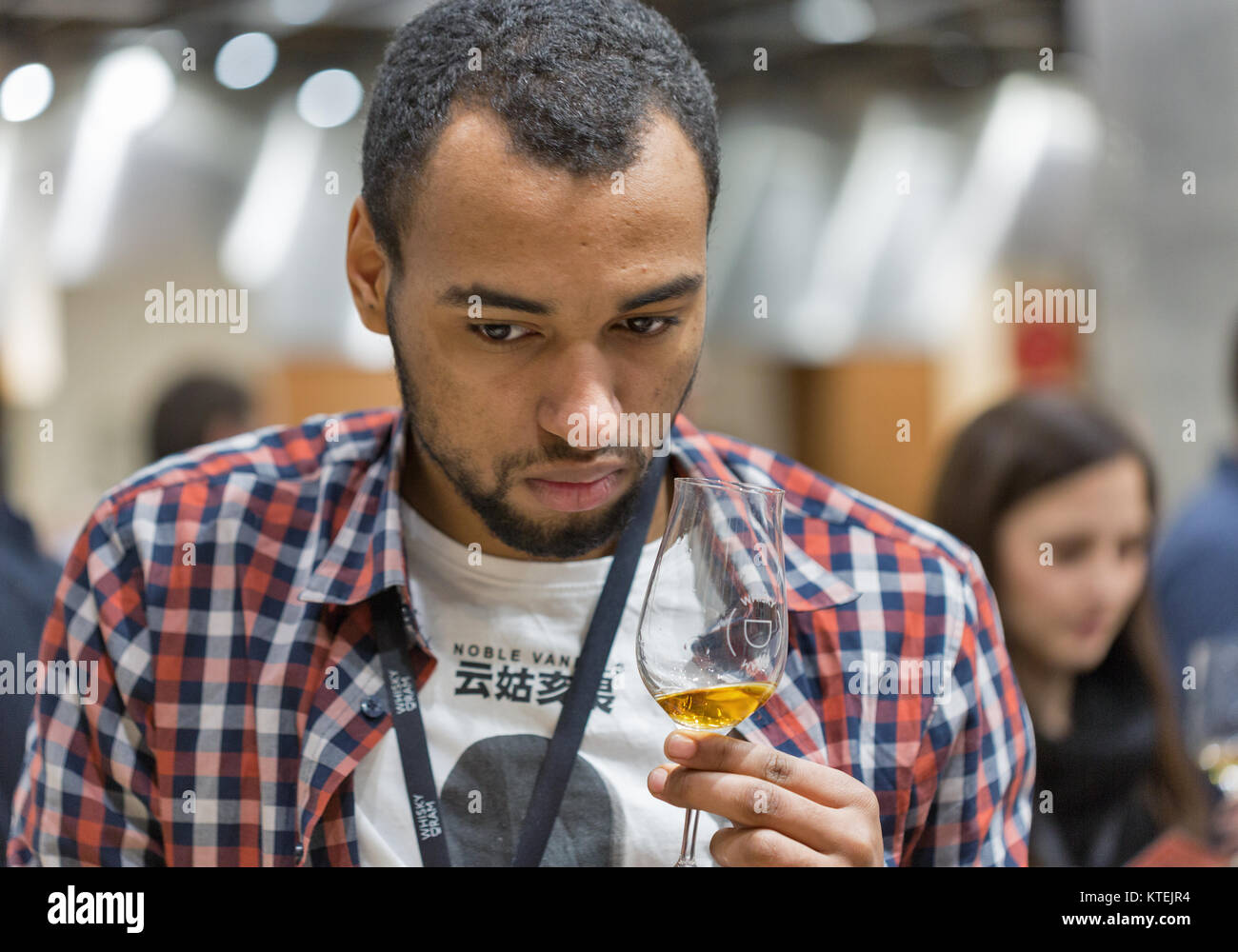 KIEV, UKRAINE - NOVEMBER 25, 2017: Unrecognized young man tasting Single Malt Scotch Whisky at 3rd Ukrainian Whisky Dram Festival in Parkovy Exhibitio Stock Photo