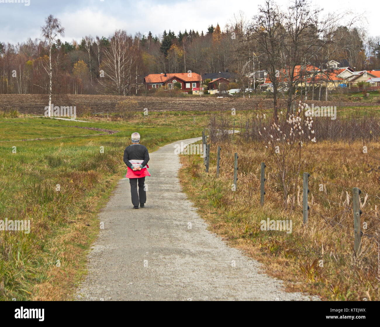 Woman walking alone in grass hi-res stock photography and images - Alamy