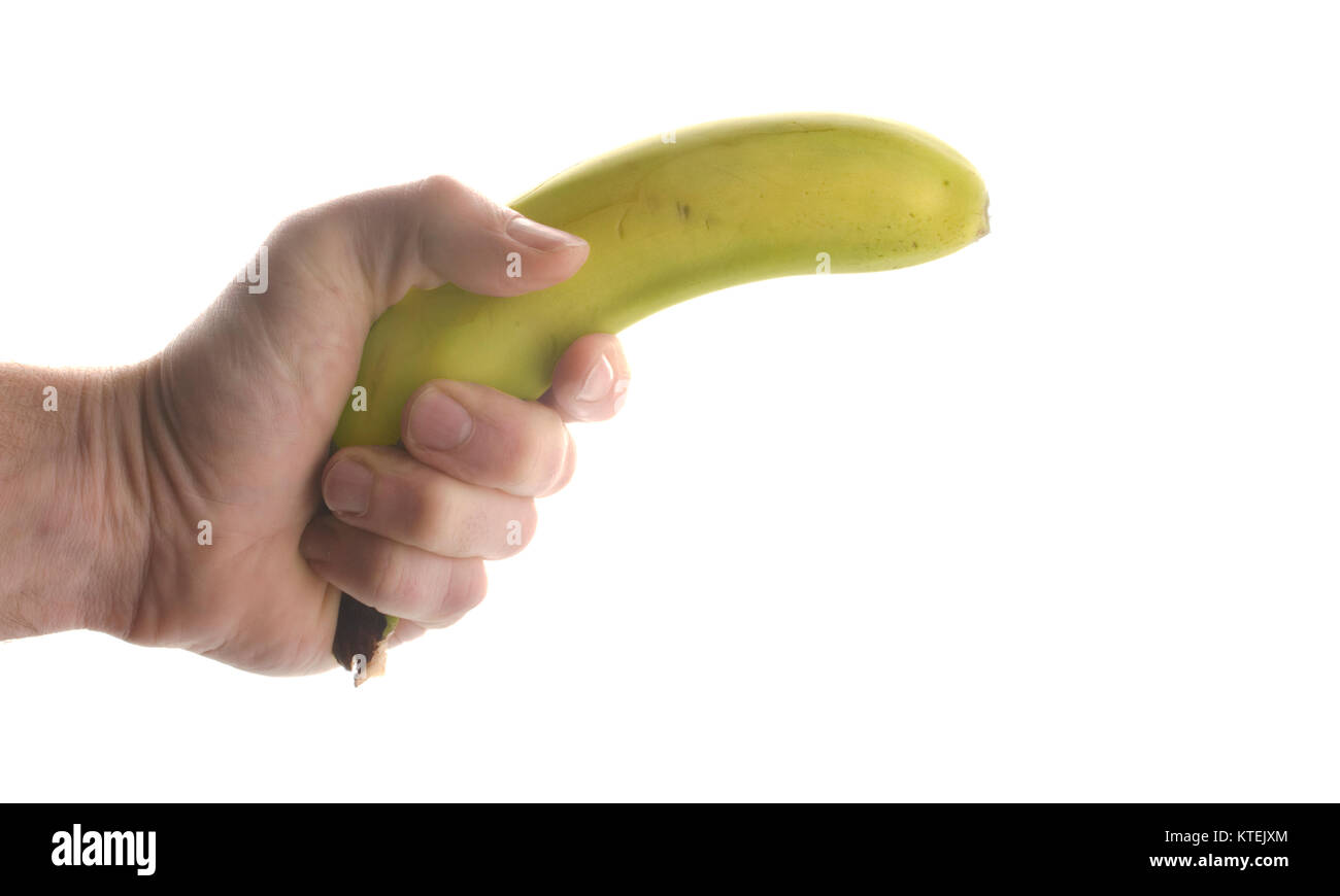 hand holding a banana like a gun, isolated on white Stock Photo Alamy