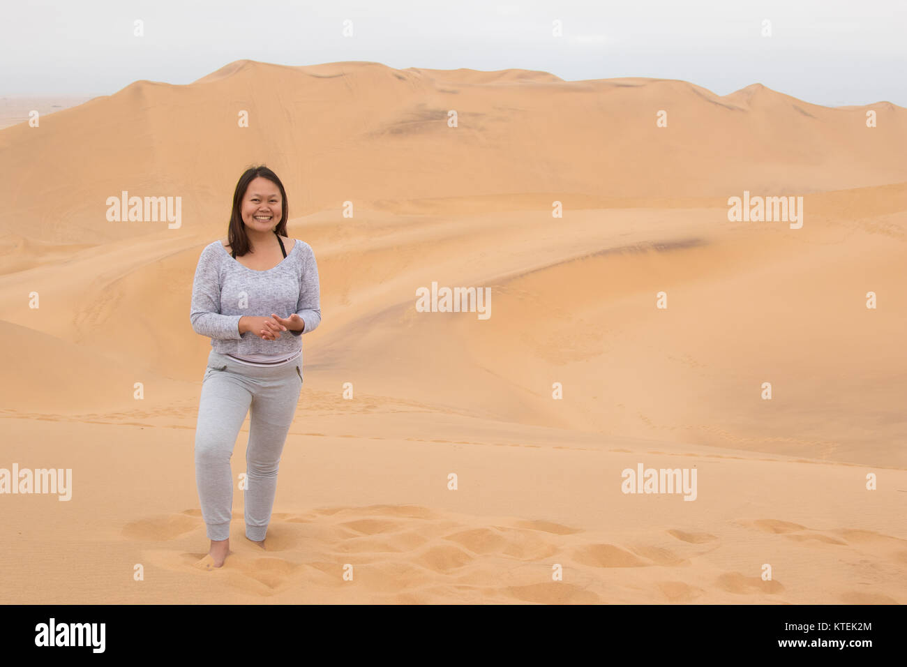 An Indonesian girl poses on Dune 7, the highest sand dune in the world