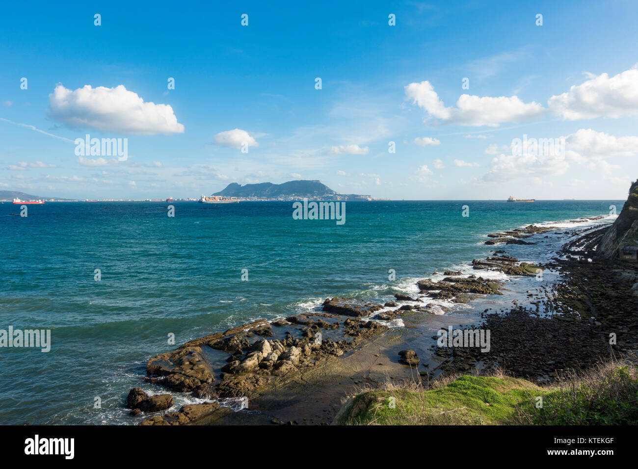 Strait of Gibraltar, with the Western face of the rock of Gibraltar and cargo ships, from Algeciras, Spain. Stock Photo