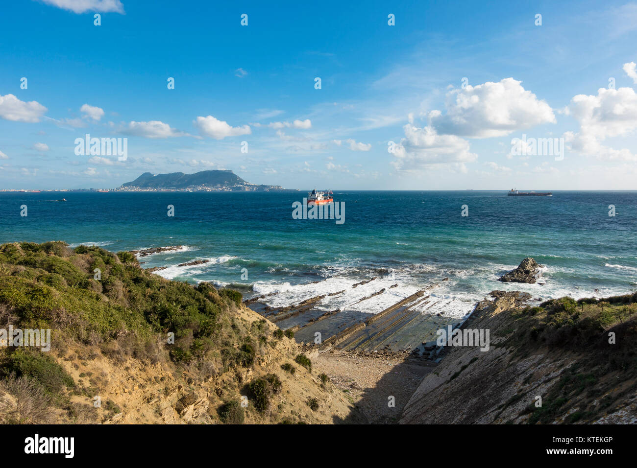 Strait of Gibraltar, with the Western face of the rock of Gibraltar and cargo ships, from Algeciras, Spain. Stock Photo