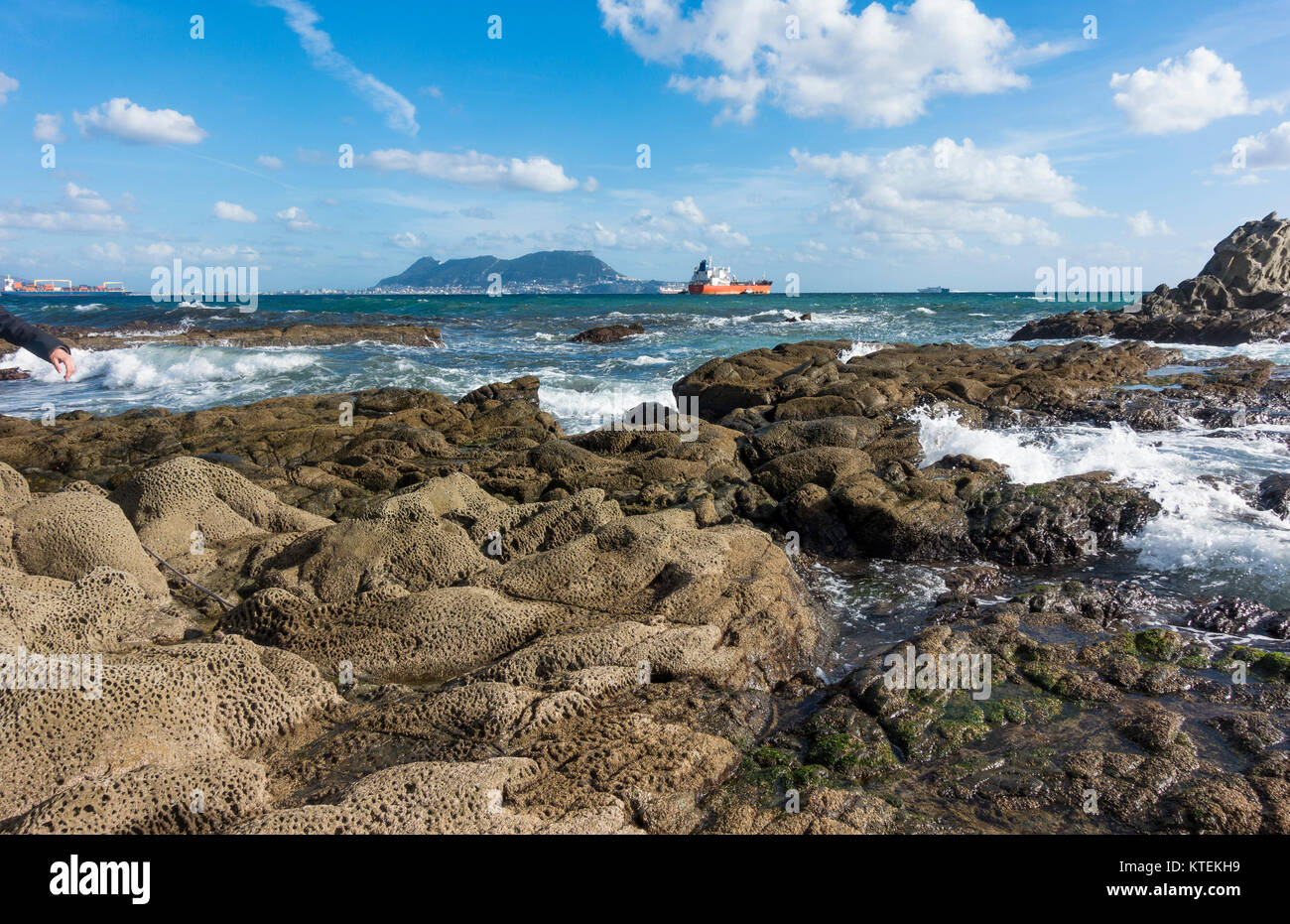 Strait of Gibraltar, with the Western face of the rock of Gibraltar and cargo ships, from Algeciras, Spain. Stock Photo