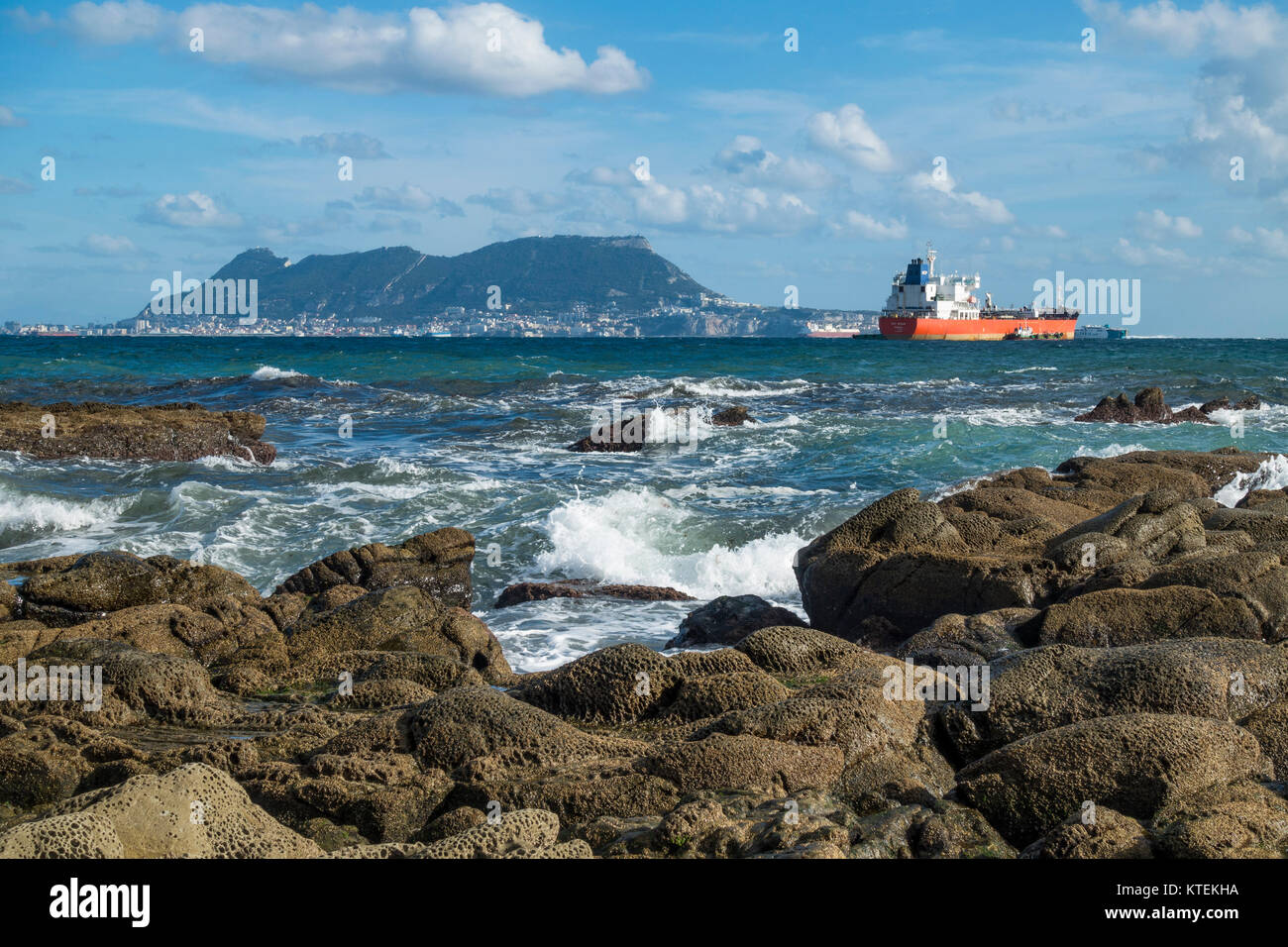 Strait of Gibraltar, with the Western face of the rock of Gibraltar and cargo ships, from Algeciras, Spain. Stock Photo