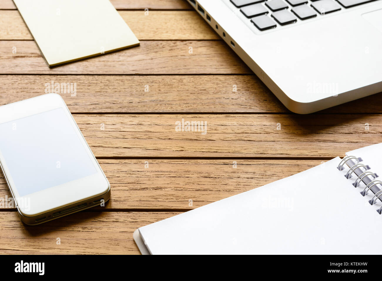 Neat wooden desktop with smartphone, laptop, notebook and notepad Stock ...