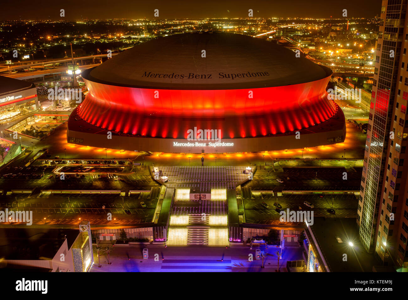 Superdome in Red - At night, Mercedes-Benz Superdome, the home stadium of New Orleans Saints football team, is lit up by bright and colorful lights. Stock Photo