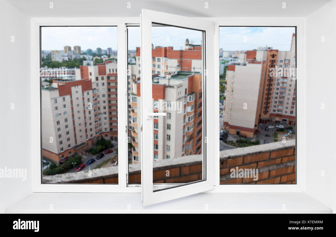 View through the pvc window frame on balcony on high floor at multi-apartment buildings Stock Photo