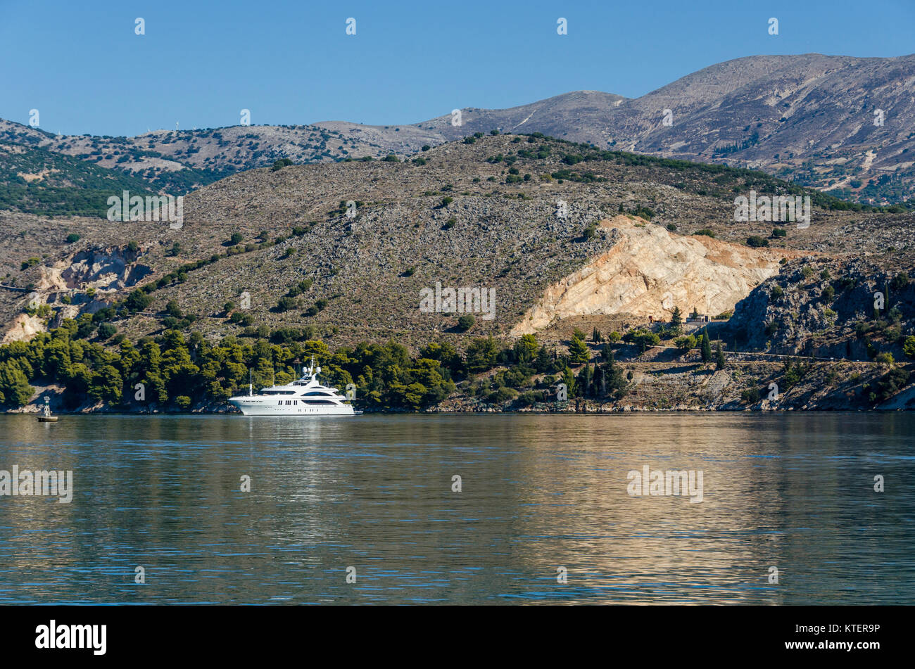 Argostoli Bay anchored yacht and hills of the island of Kefalonia on the Ionian Sea Stock Photo