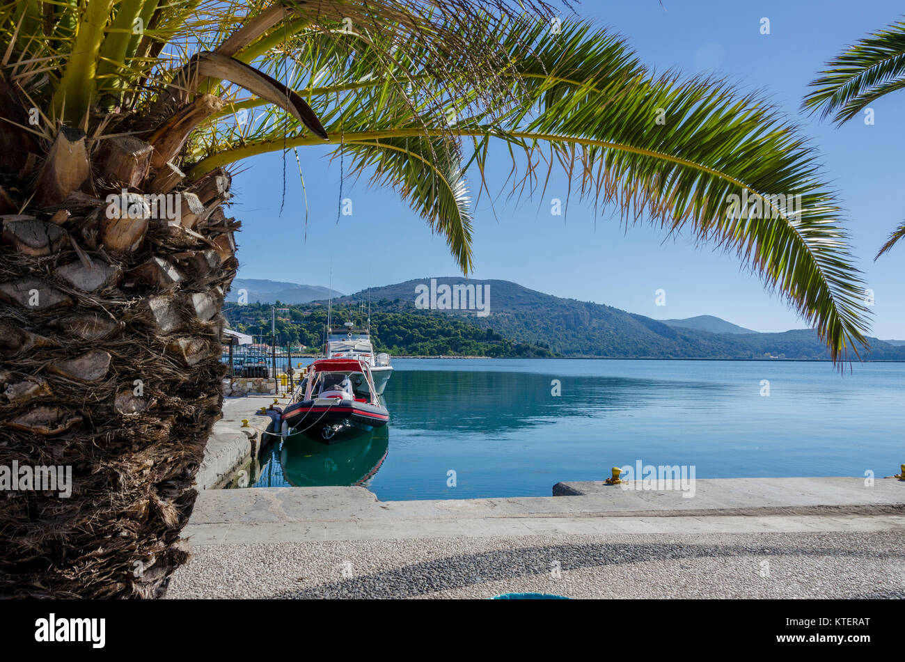 Boat anchored in a dock of the port and city of Argostoli main city and capital of the island of Kefalonia Stock Photo