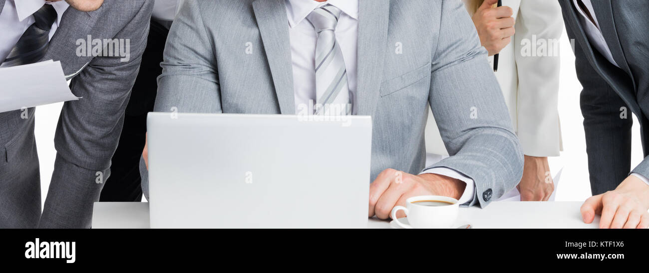 Business team working with laptop together Stock Photo - Alamy