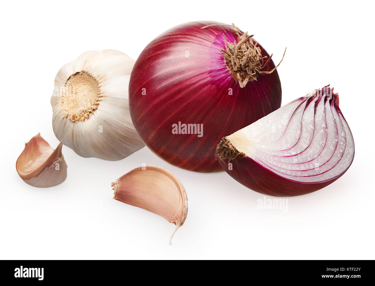 Whole fresh unpeeled red onion with slice and garlic with cloves ...