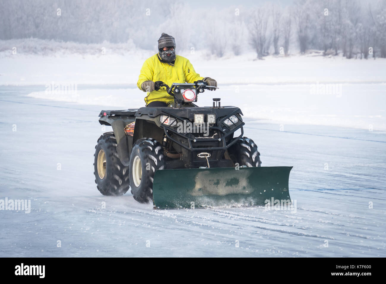 snowplow removing snow on the street after blizzard. ATV converted into
