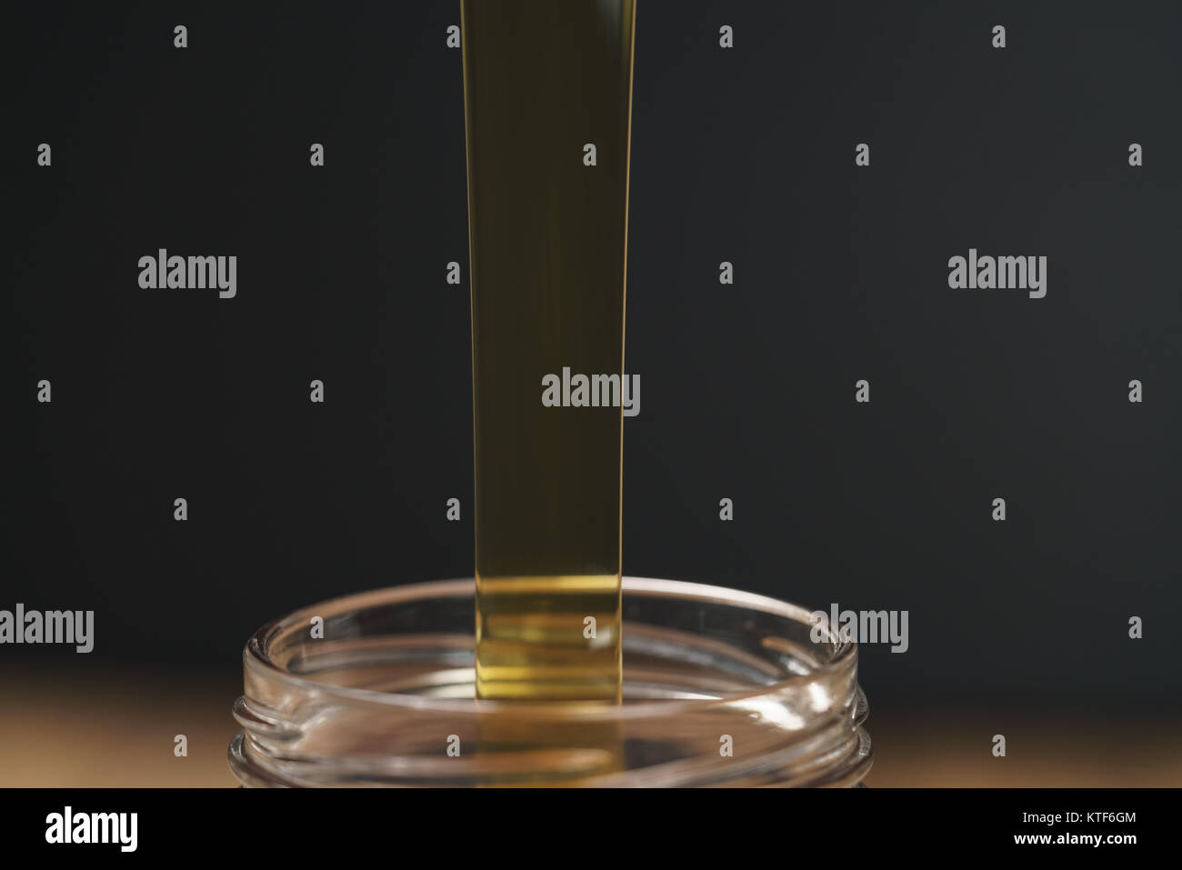 pour honey into glass jar closeup Stock Photo Alamy