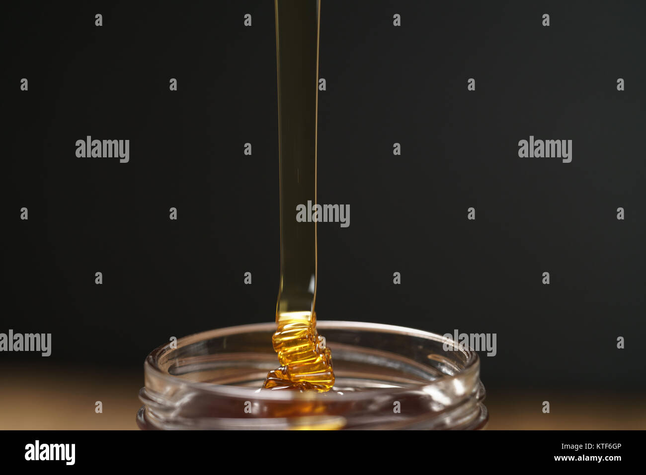 pour honey into glass jar closeup Stock Photo Alamy