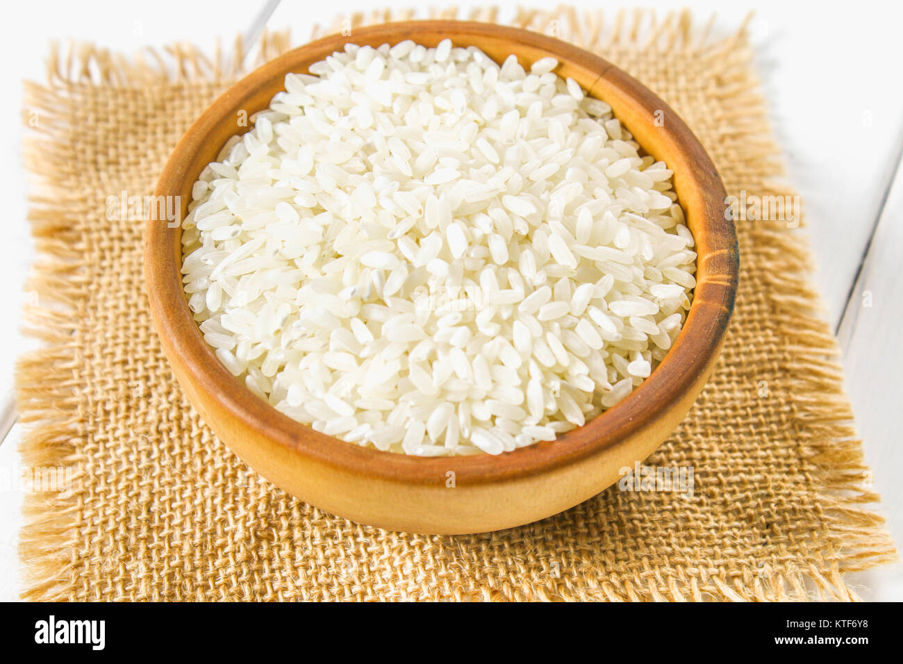 White Items Rice Grains of raw white rice on a white wooden table of boards. Ingredients ...