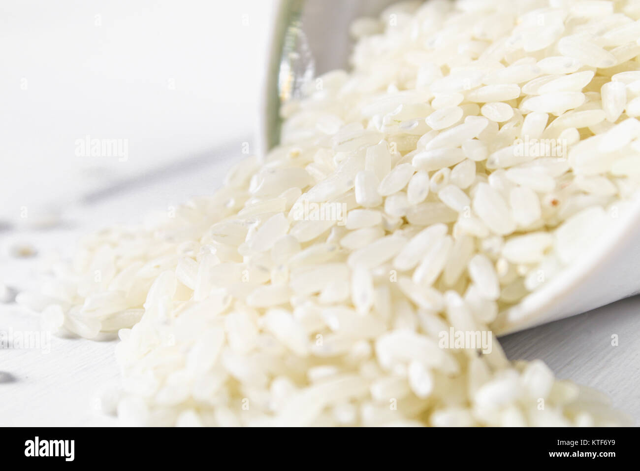 White Items Rice Grains of raw white rice on a white wooden table of boards. Ingredients ...