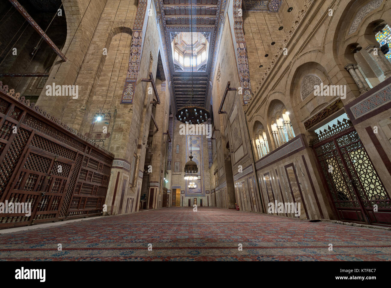 Cairo, Egypt - December 16 2017: Interior of al Refai mosque with old decorated bricks stone wall, colored marble decorations, wooden ornate ceiling,  Stock Photo