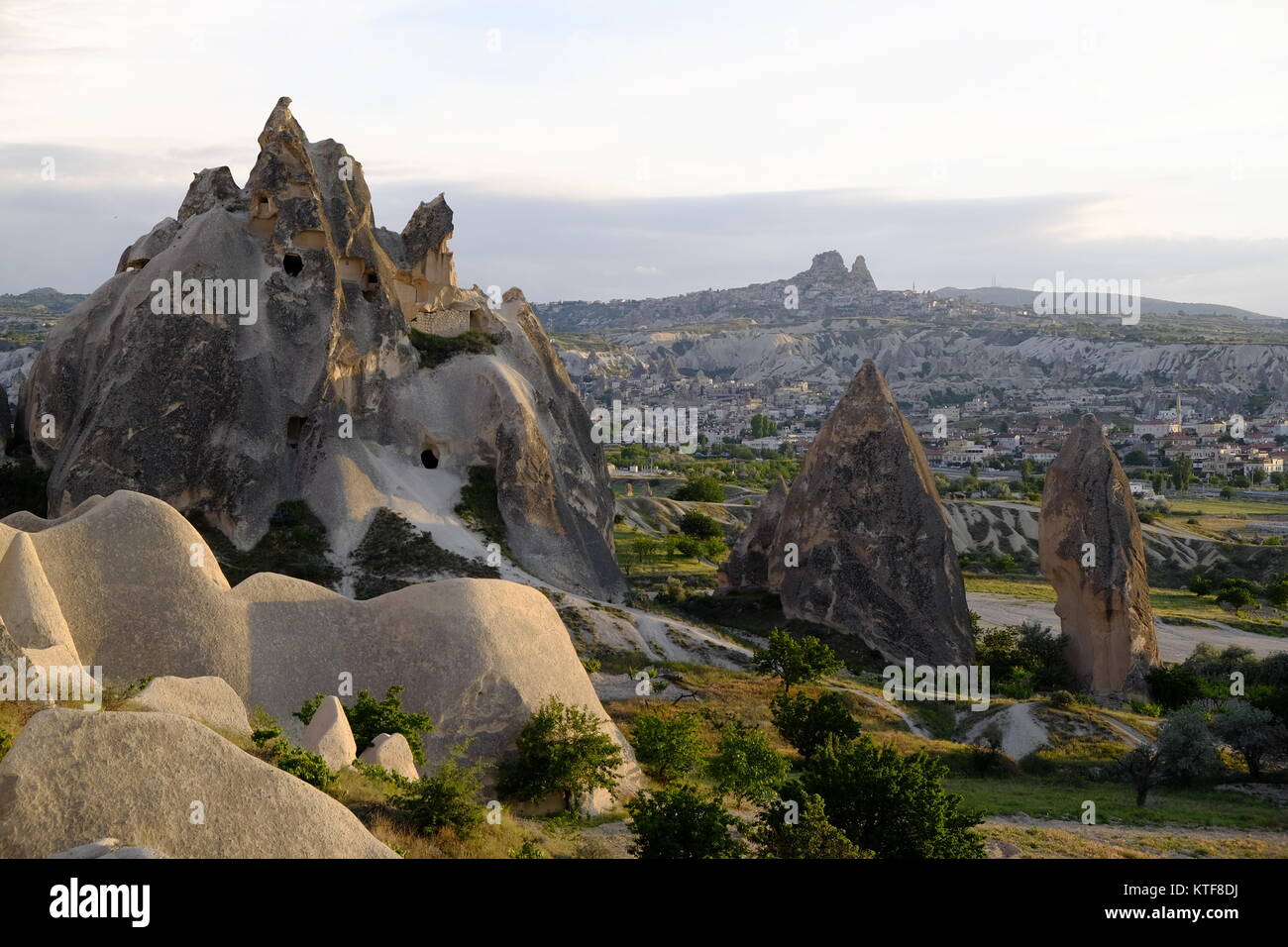 Ancient cave homes in Cappadocia with Göreme and the fort of Uchisar in