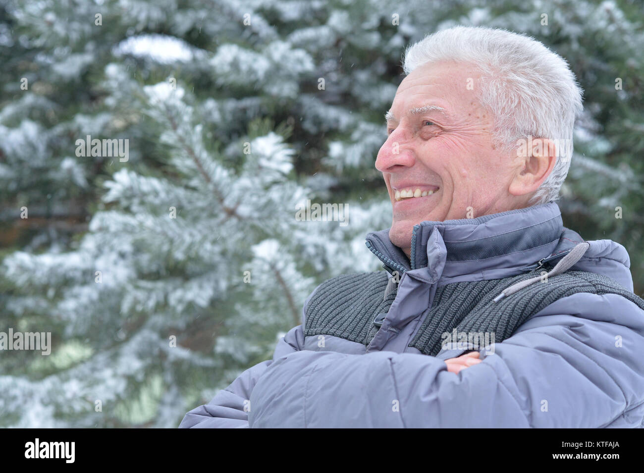 Portrait of smiling senior man standing outdoors in winter Stock Photo ...