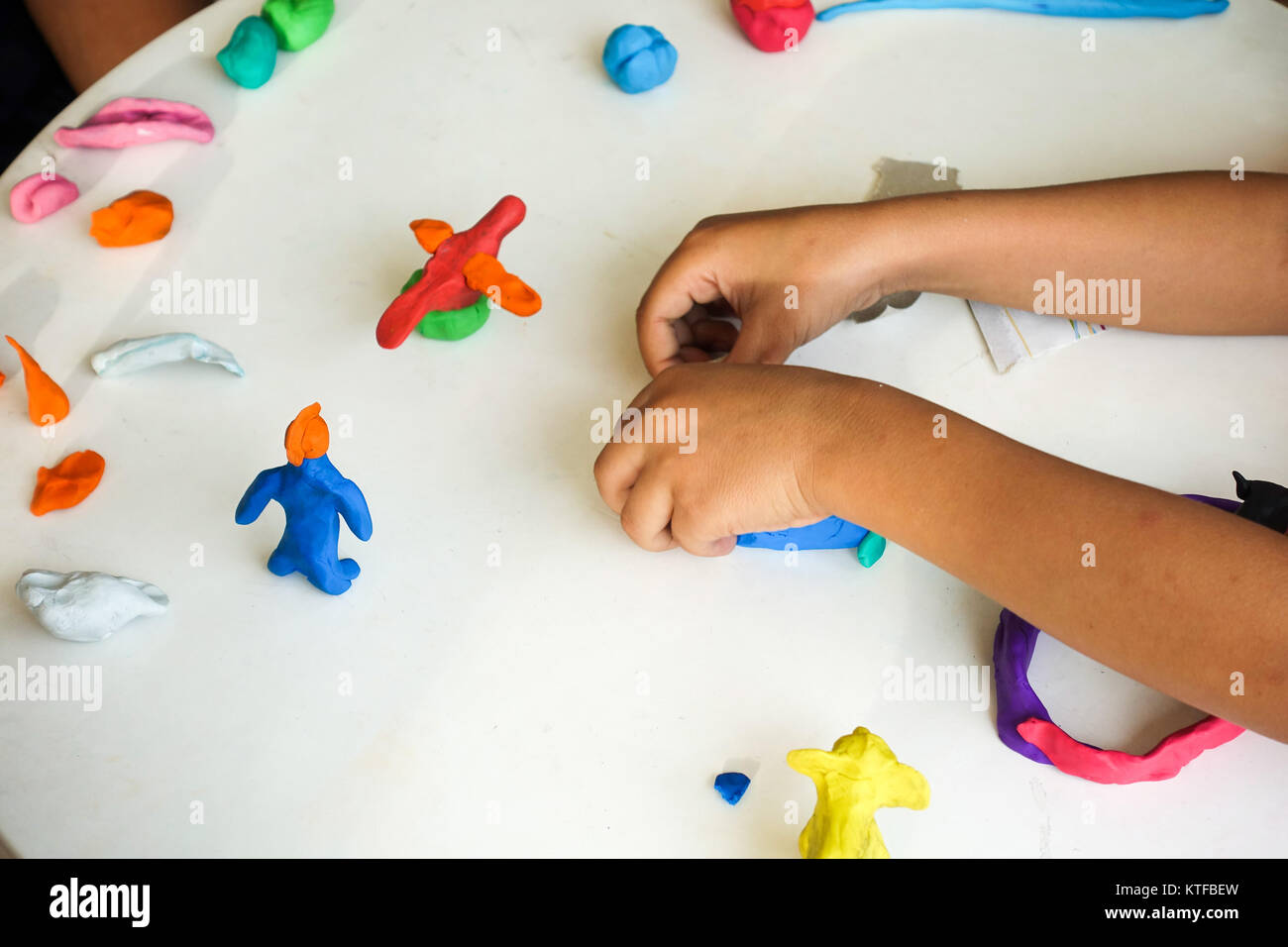 An opened plastic Play Doh container on a table Stock Photo - Alamy