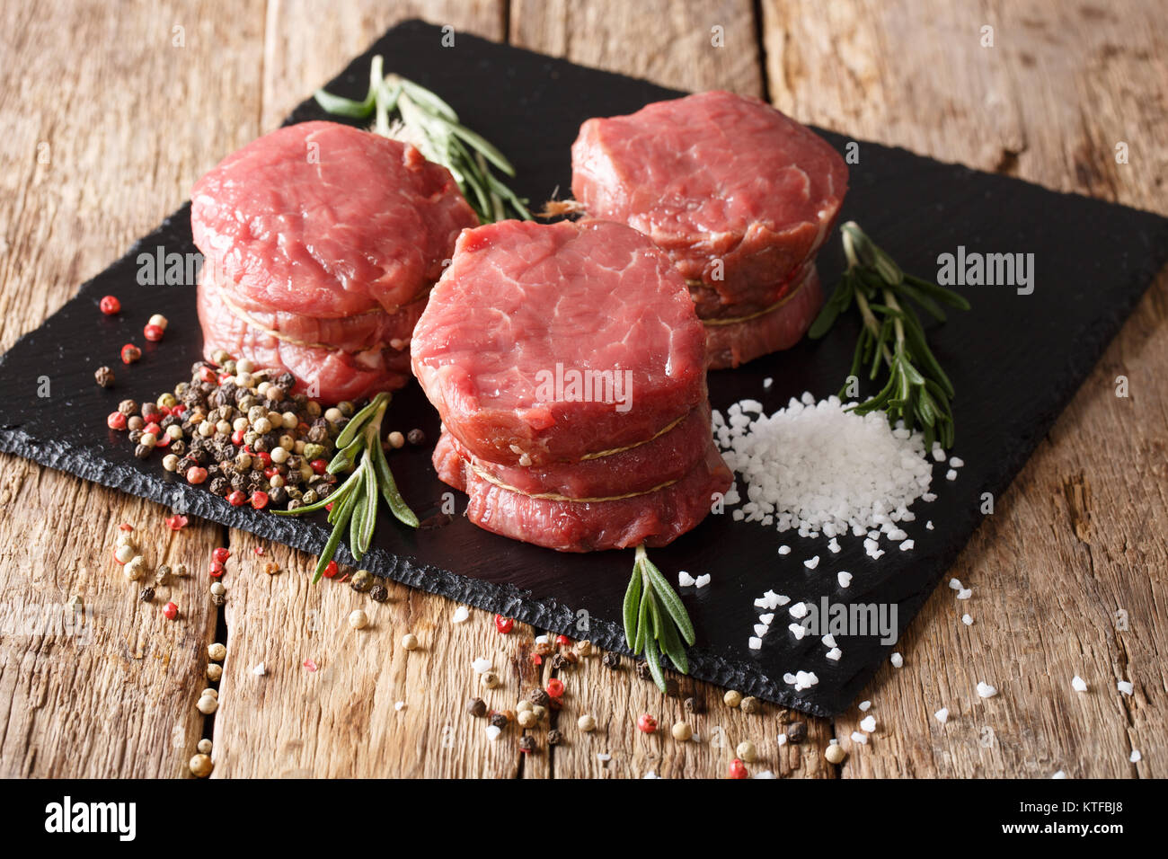 fresh raw beef fillet mignon on old wooden background close up. Horizontal Stock Photo