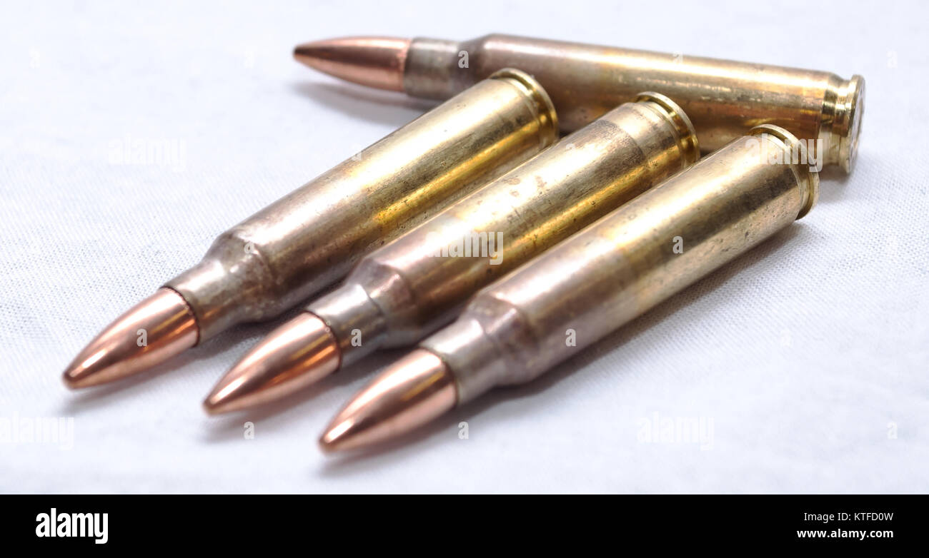 Four .223 caliber bullets on a white background Stock Photo