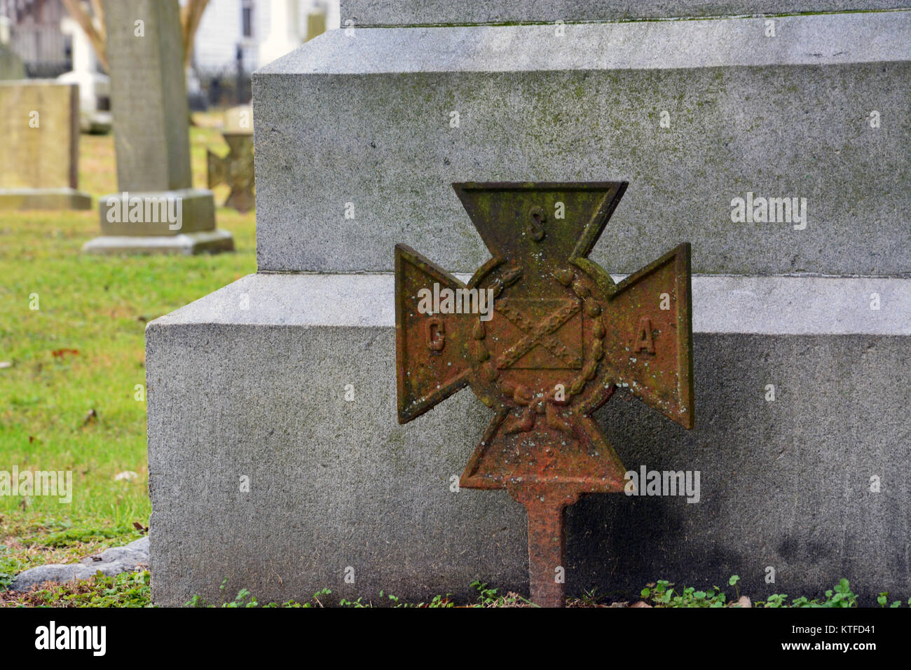 An old weathered CSV Iron Cross signifying the grave site of a