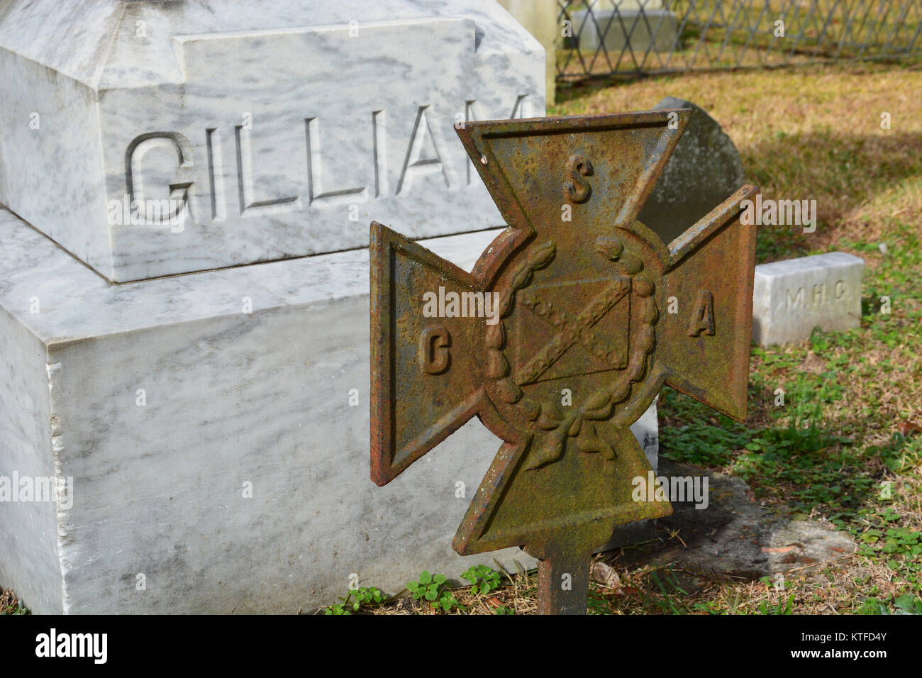 An old weathered CSV Iron Cross signifying the grave site of a confederate solder at a rural southern church cemetery Stock Photo