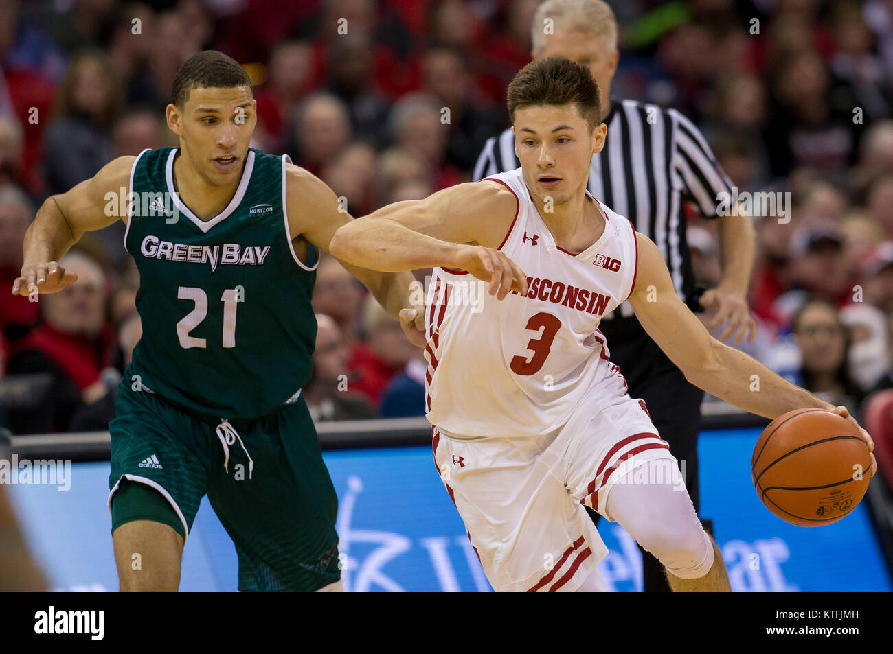 Madison, WI, USA. 23rd Dec, 2017. Wisconsin Badgers guard Walt McGrory #3 drives past Green Bay Phoenix guard Kameron Hankerson #21 during the NCAA Basketball game between the Green Bay Phoenix and the Wisconsin Badgers at the Kohl Center in Madison, WI. Wisconsin defeated Green Bay 81-60. John Fisher/CSM/Alamy Live News Stock Photo