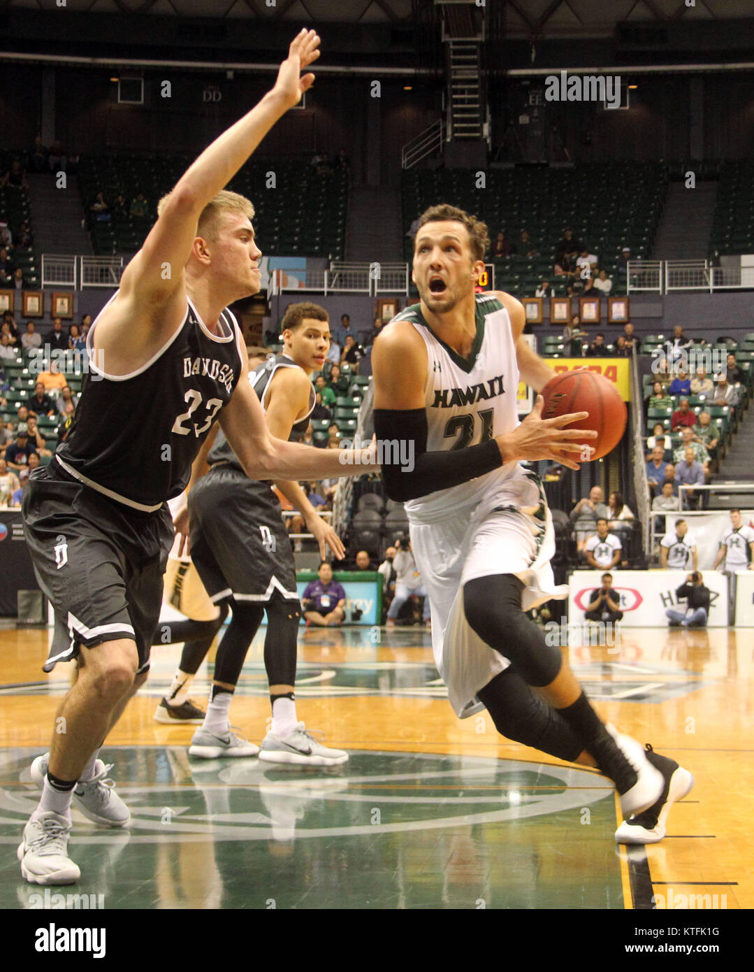 December 23, 2017 - Hawaii Rainbow Warriors forward Gibson Johnson (21) drives the lane on Davidson Wildcats forward Peyton Aldridge (23) during game between Davidson Wildcats and the Hawaii Rainbow Warriors at the Hawaiian Airlines Diamond Head Classic at the Stan Sheriff Center on the campus of the University of Hawaii in Honolulu, Hawaii - Michael Sullivan/CSM Credit: Cal Sport Media/Alamy Live News Stock Photo