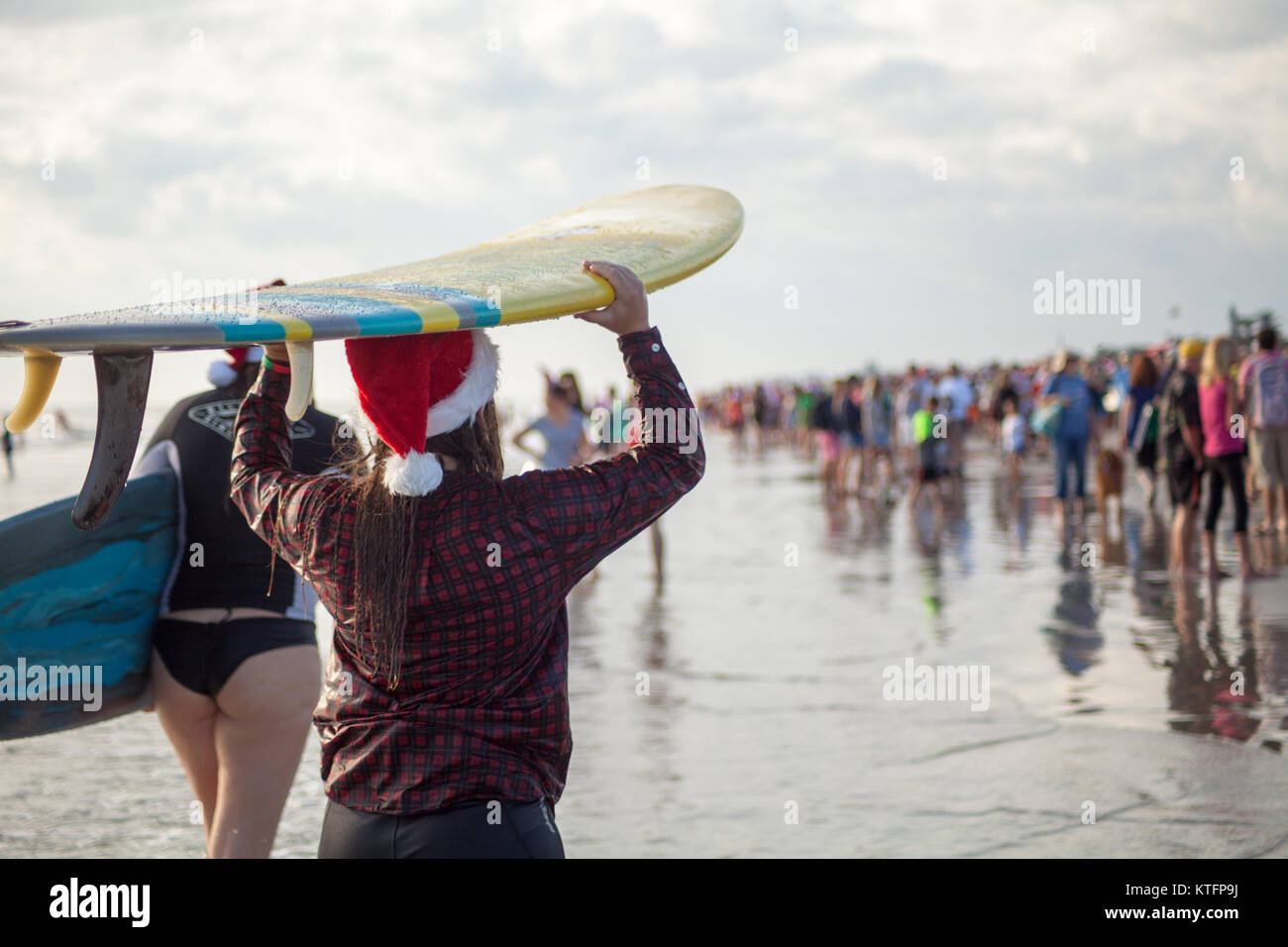 Cocoa Beach, Florida, USA. 24th Dec, 2017. Surfing Santas, an annual