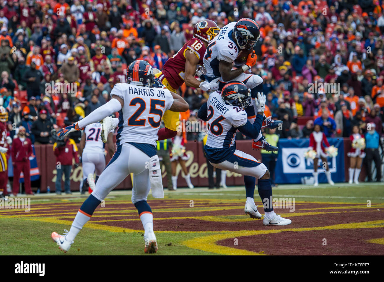 Landover, MD, USA. 24th Dec, 2017. Denver Broncos safety Will Parks (34) picks off the pass from Washington Redskins quarterback Kirk Cousins (8) in the end zone during the season ending home matchup between the Denver Broncos and the Washington Redskins at FedEx Field in Landover, MD. Credit: csm/Alamy Live News Stock Photo
