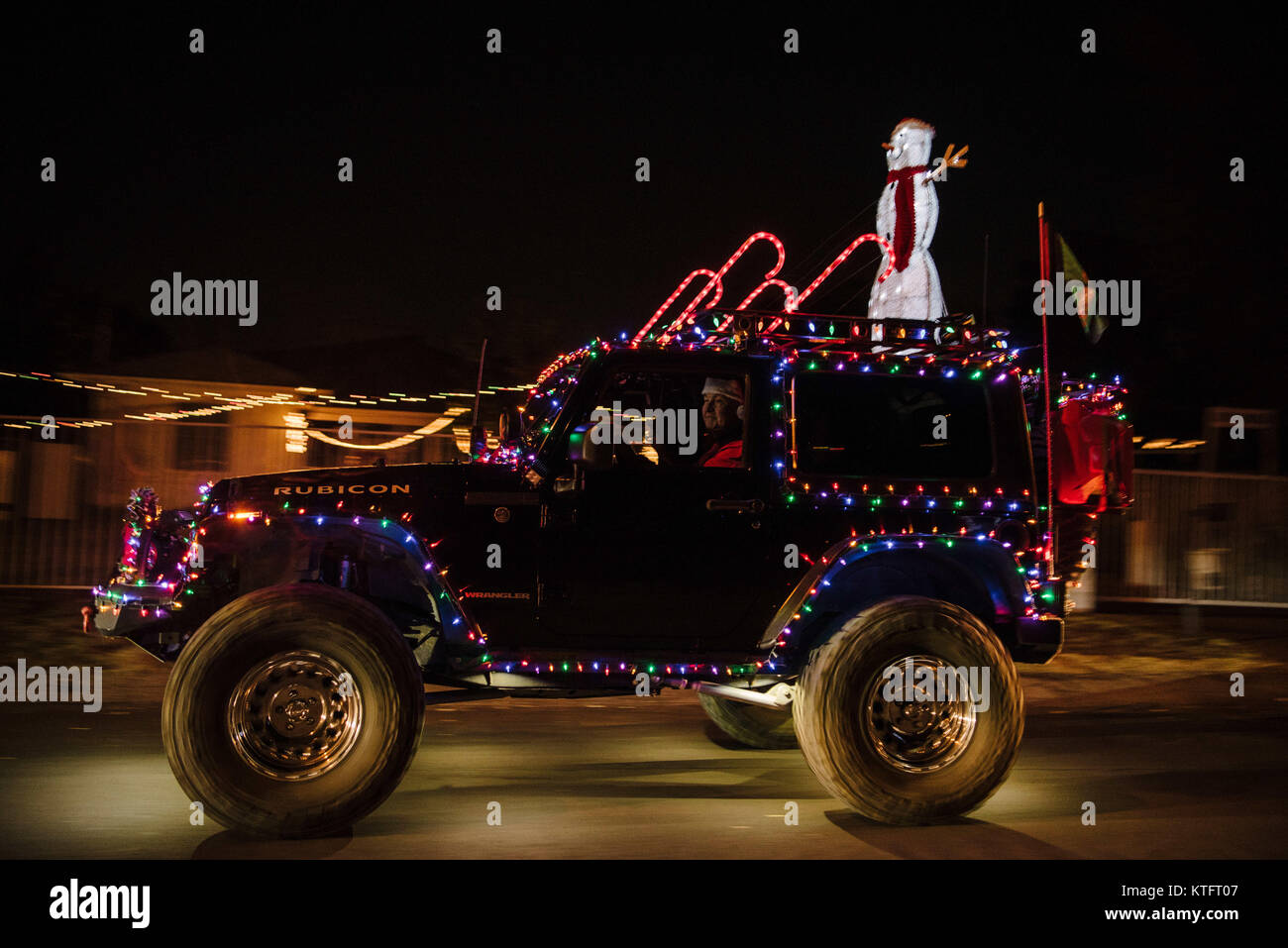 Woodland Hills, California, USA. 24th Dec, 2017. A decorated Jeep Wrangler  drives through ''Candy Cane Lane'' on Christmas Eve in Woodland Hills,  California. Credit: Morgan Lieberman/ZUMA Wire/Alamy Live News Stock Photo -