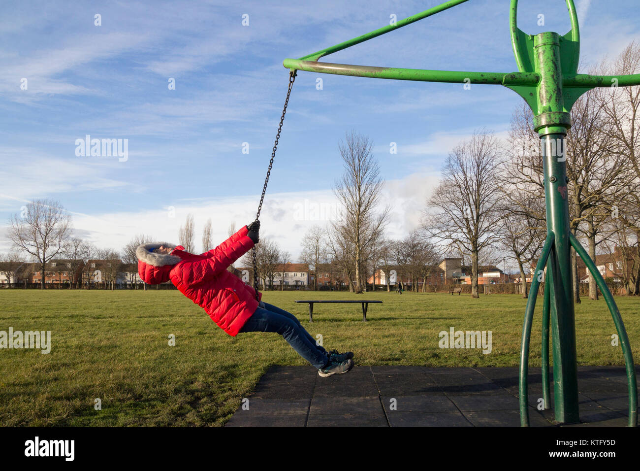 Mature woman playing on swing in park hi-res stock photography and ...