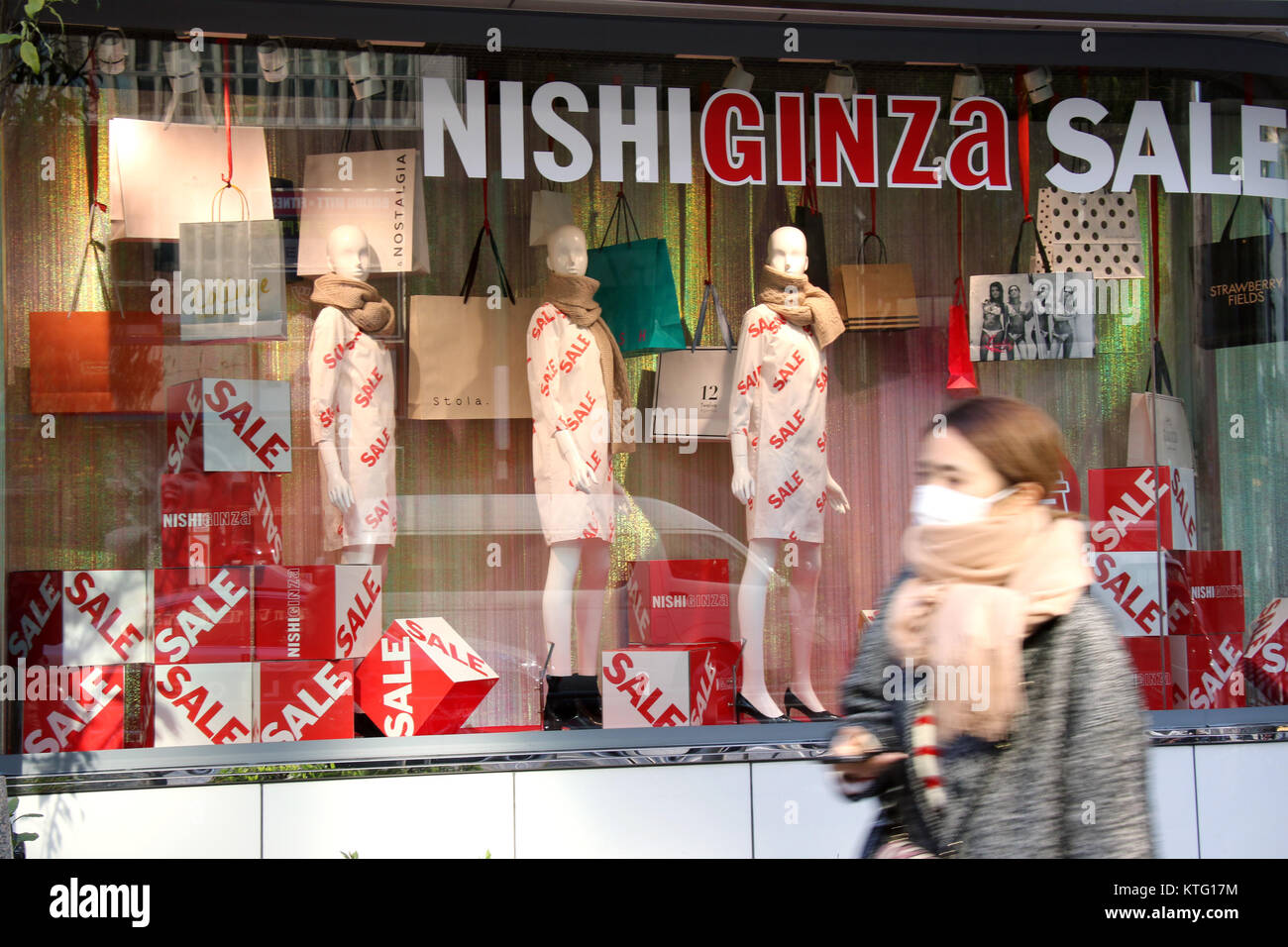 Tokyo, Japan. 26th Dec, 2017. A pedestrian passes before an aparel shop in Tokyo on Tuesday, December 26, 2017. Japan's consumer price index rose 0.9 percent in November, increasing 11th consecutive month, the government announced on December 26. Credit: Yoshio Tsunoda/AFLO/Alamy Live News Stock Photo