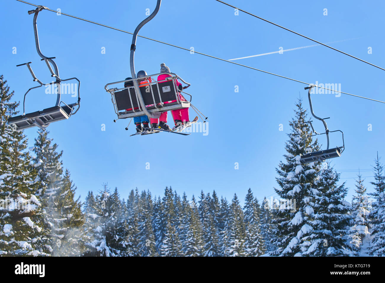 Skiers and snowboarders on a ski lift Stock Photo - Alamy