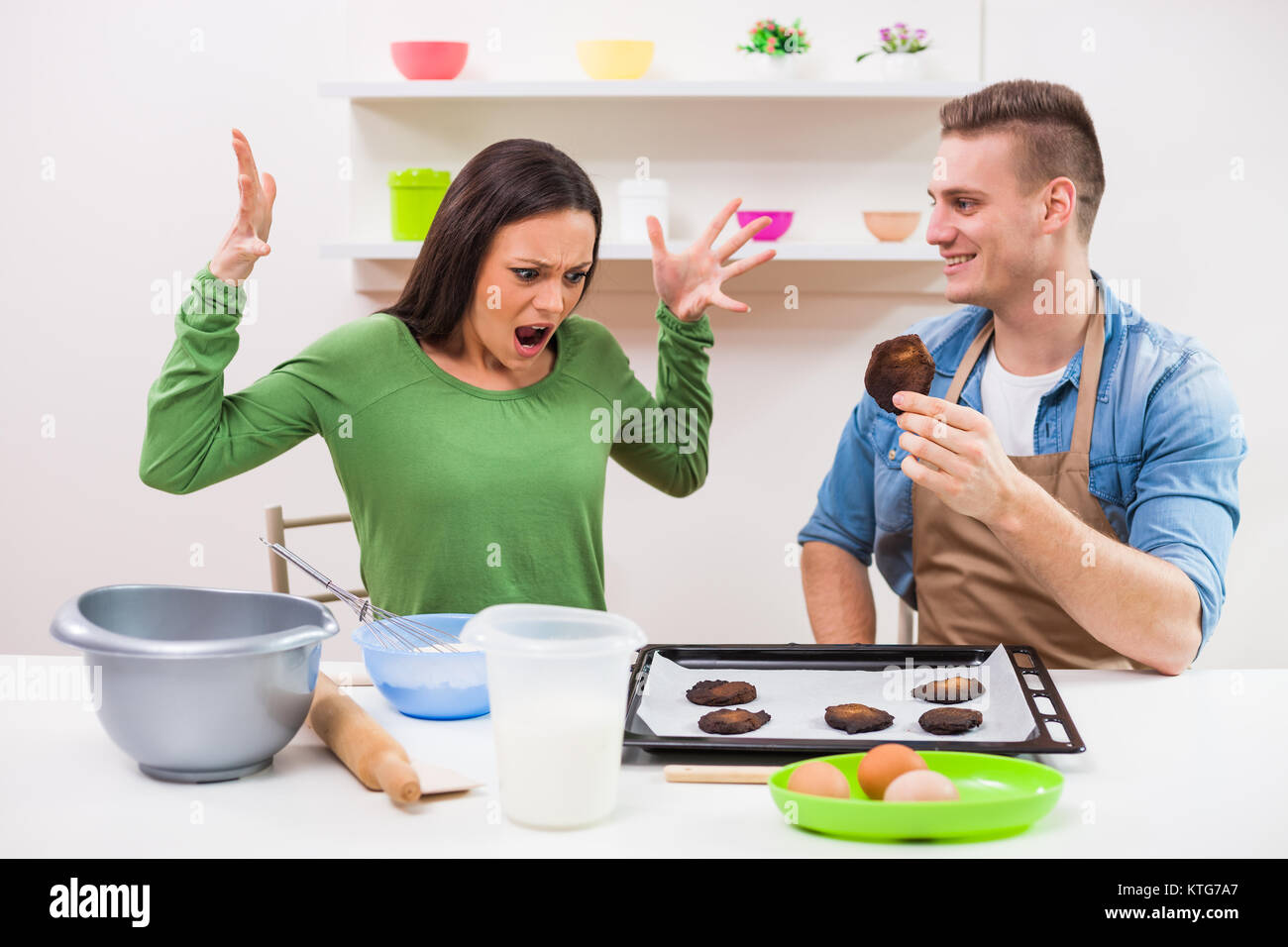 Young couple cooking in their kitchen. Stock Photo