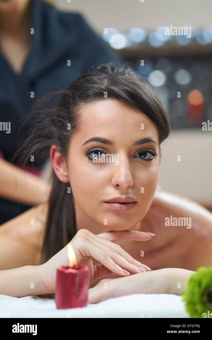 Spa woman. Female enjoying relaxing back massage in cosmetology spa centre. Body care, skin care