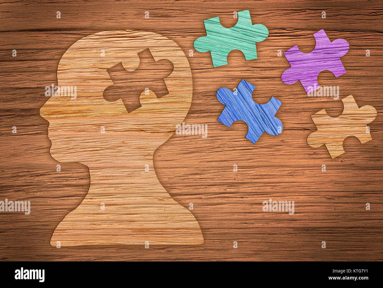 Puzzle head brain concept. Human head profile made from brown paper with a jigsaw piece cut out. Stock Photo