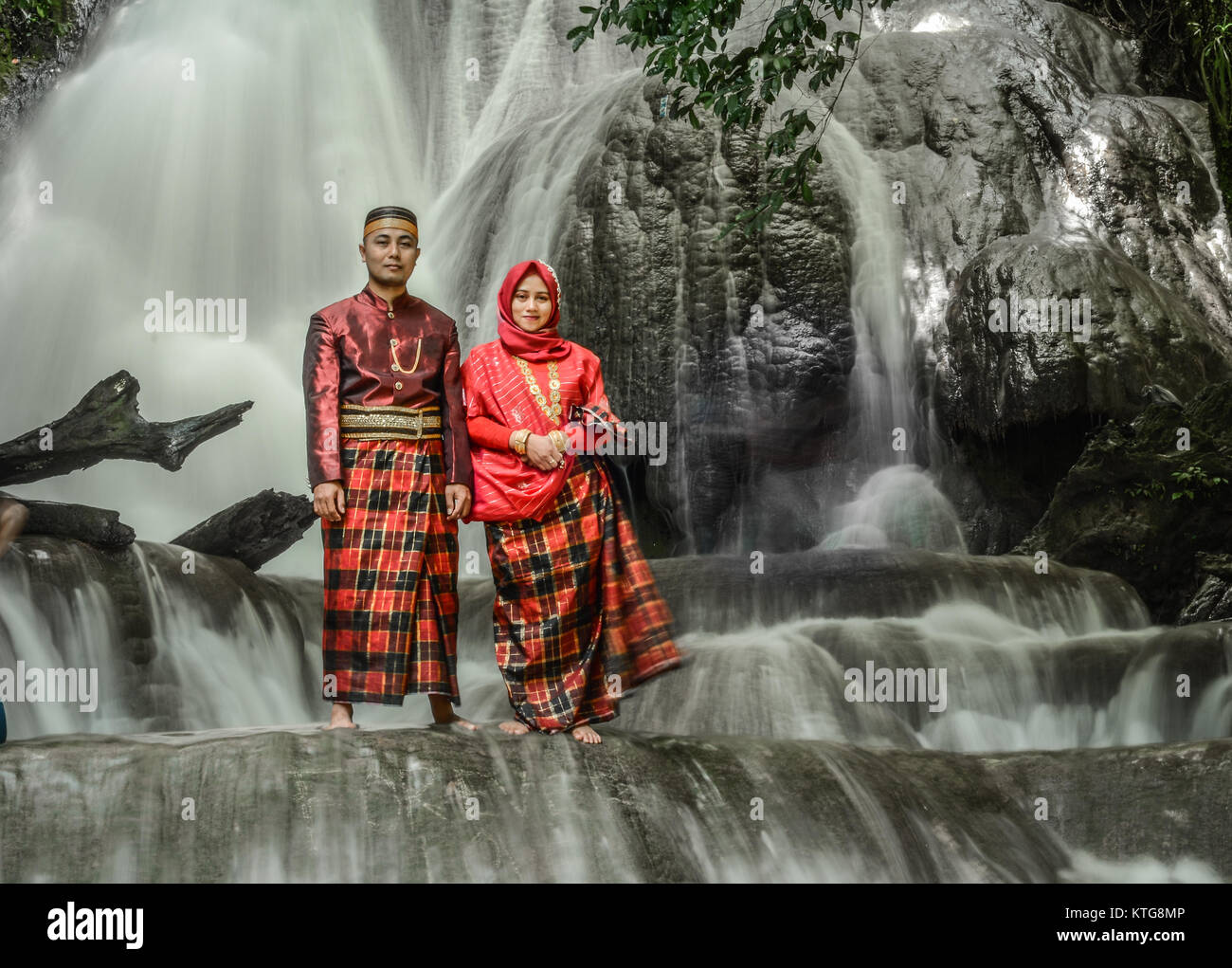 A young couple poses in traditional Bugis dress. Stock Photo