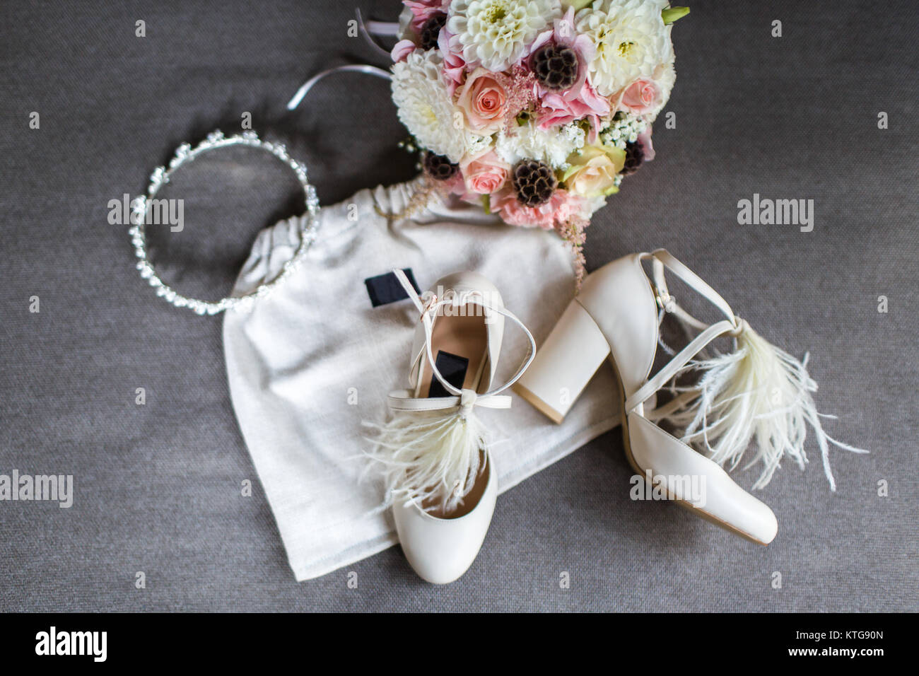 Wedding shoes, tiara and bouquet on a gray background Stock  display picture 2