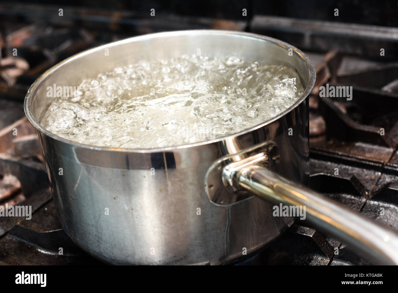 Water boiling in a pan on a range Stock Photo