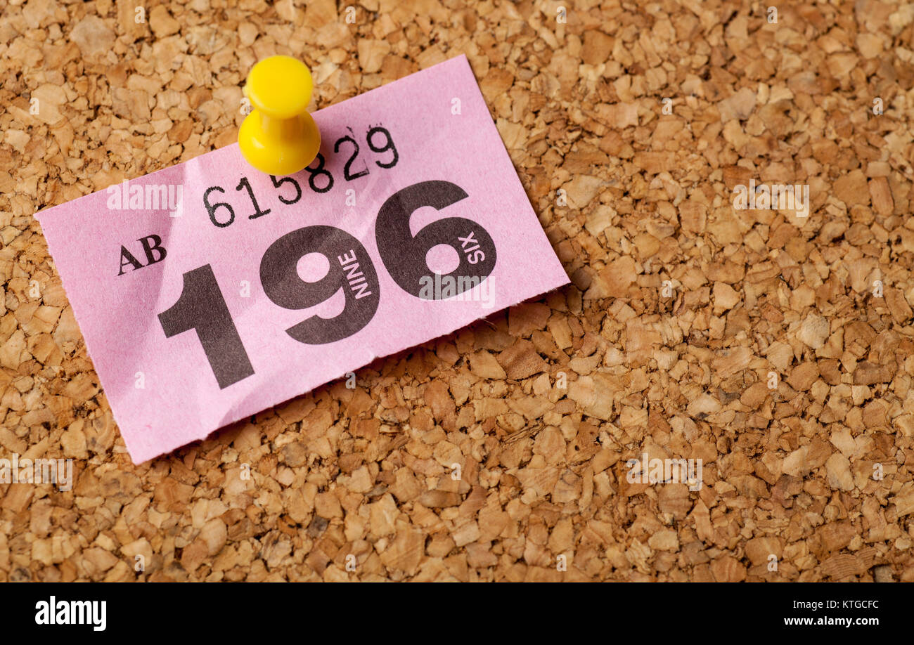 Pink Raffle ticket pinned onto a cork notice board Stock Photo Alamy