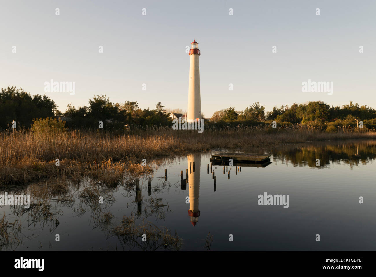 Reflection of Cape May Lighthouse over lighthouse pond during sunrise hours at Wetlands Natural area (Cape May). South New Jersey area. Stock Photo