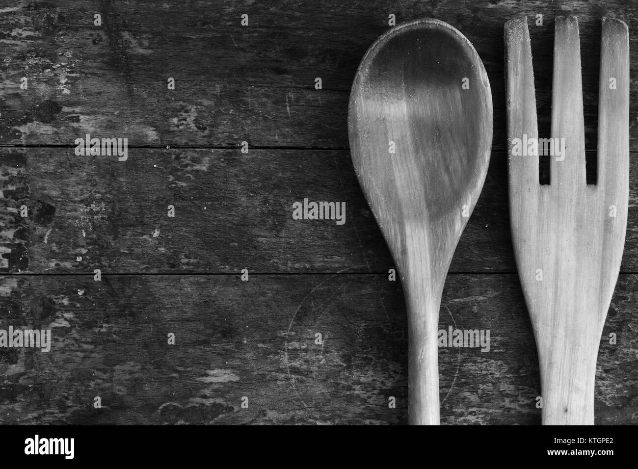 Old texture background dirty shabby barn boards and wooden spoon and fork. The concept of rustic kitchen. Top view. Free space for text. Copy space. B Stock Photo