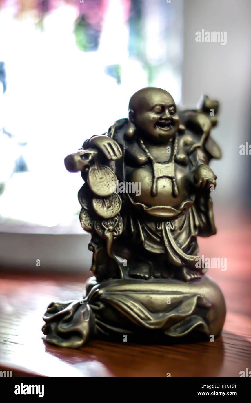 Interior shallow depth of field low light stock photo of bronze buddha statue Stock Photo